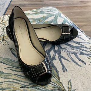 AK 1/2 inch heel , with decorative silver buckle and cream stitching .